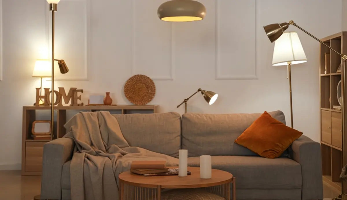 Interior of living room with sofa, table and glowing lamps in evening