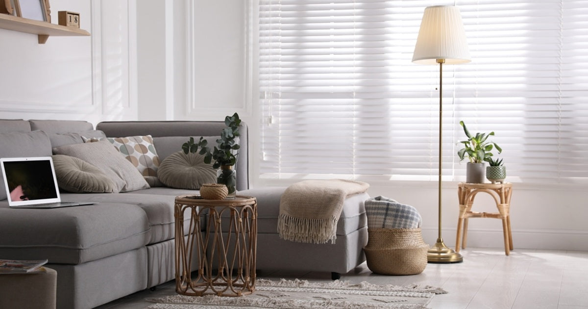 Living room with comfortable grey sofa and floor lamp