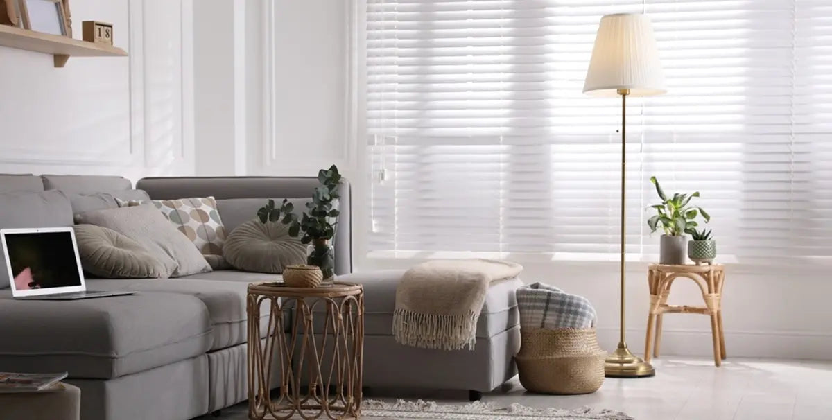 Living room with comfortable grey sofa and floor lamp