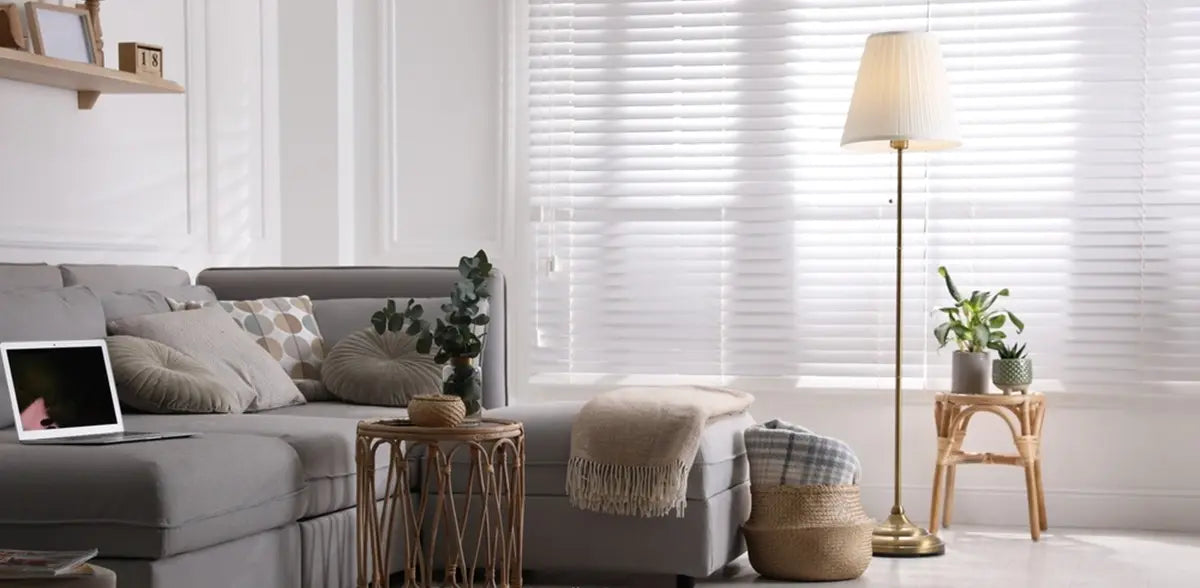 Living room with comfortable grey sofa and stylish floor lamp