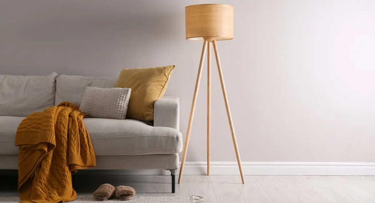 Tripod floor lamp next to sofa