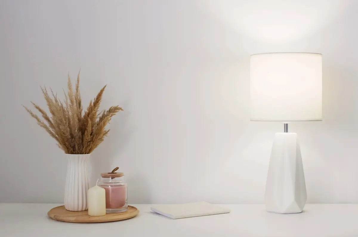 White table lamp on wooden frame with white wall background